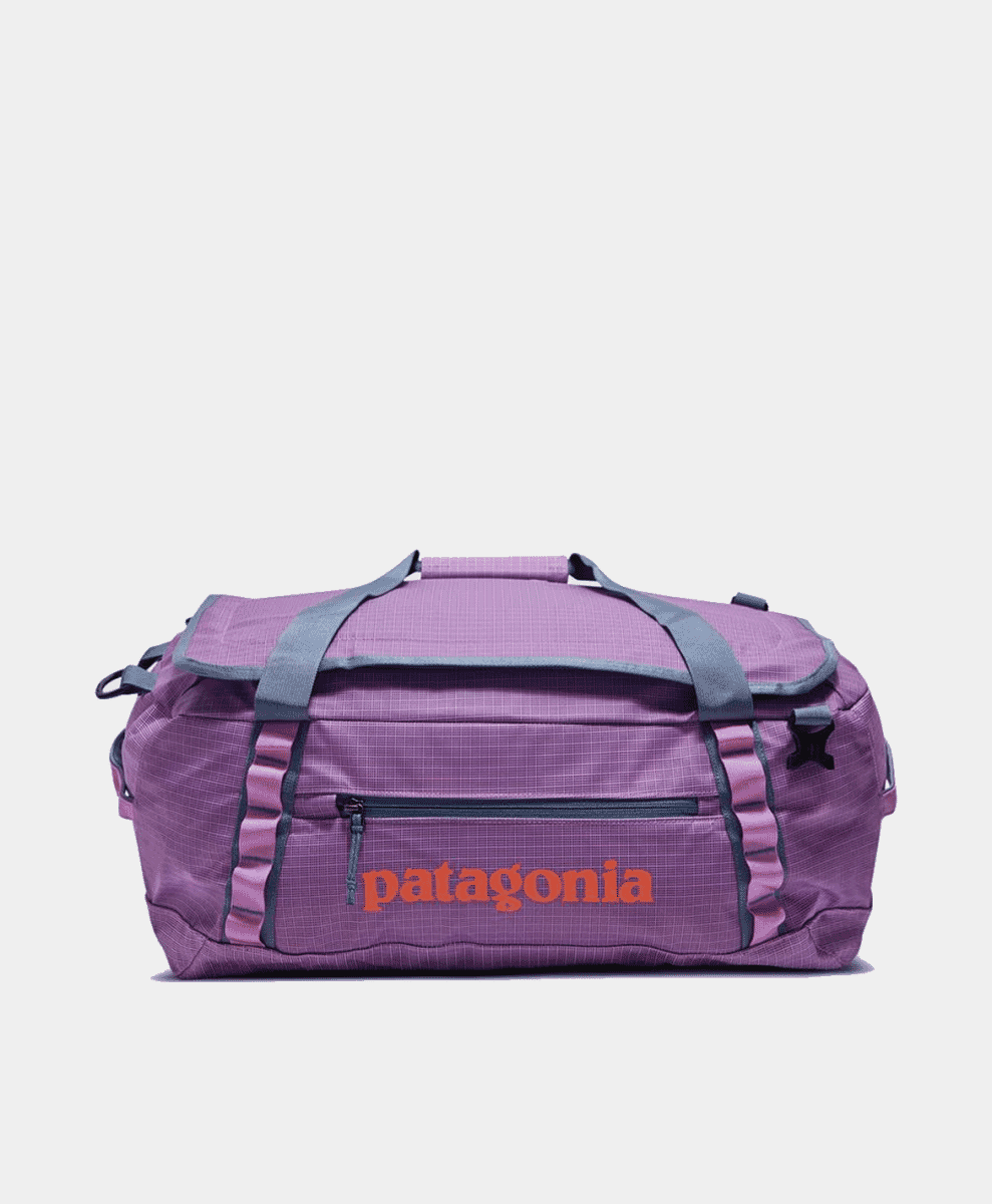 A purple Patagonia Black Hole Duffel bag with orange branding.