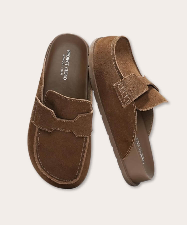 Close-up of brown suede clogs styled with denim.