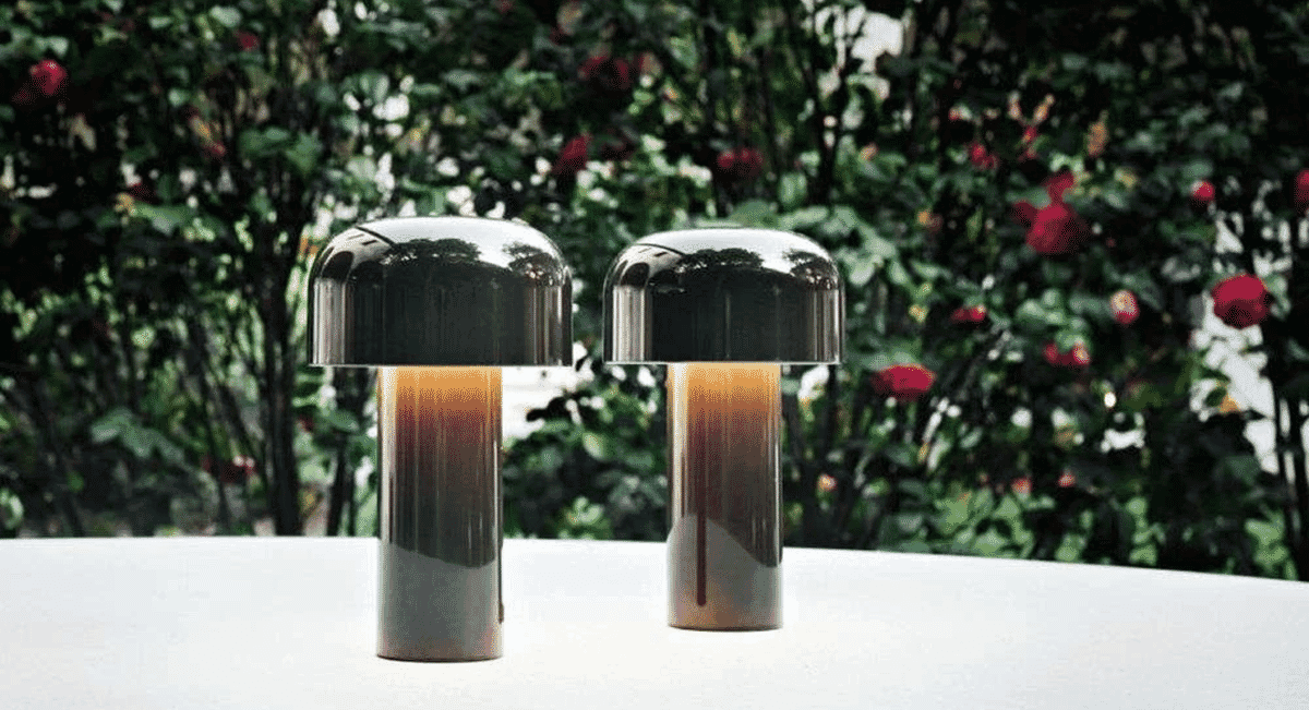 Two modern metallic table lamps with a warm glowing light.