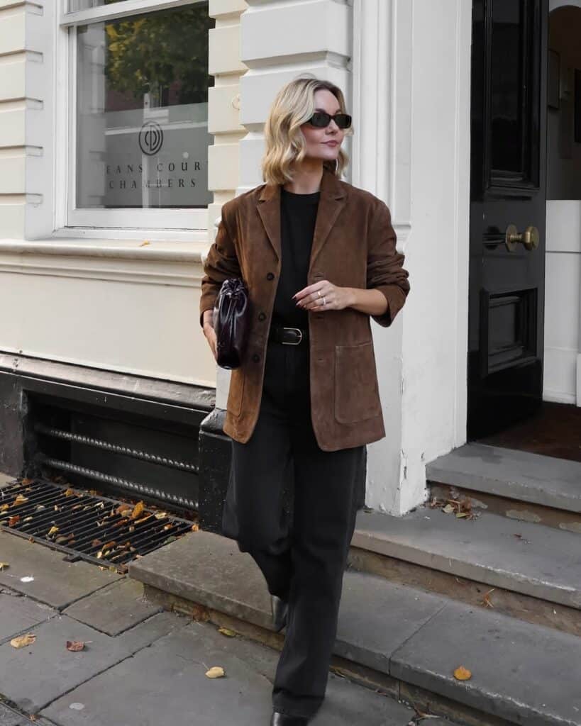 An oversized structured blazer worn over a crisp light-colored poplin shirt.