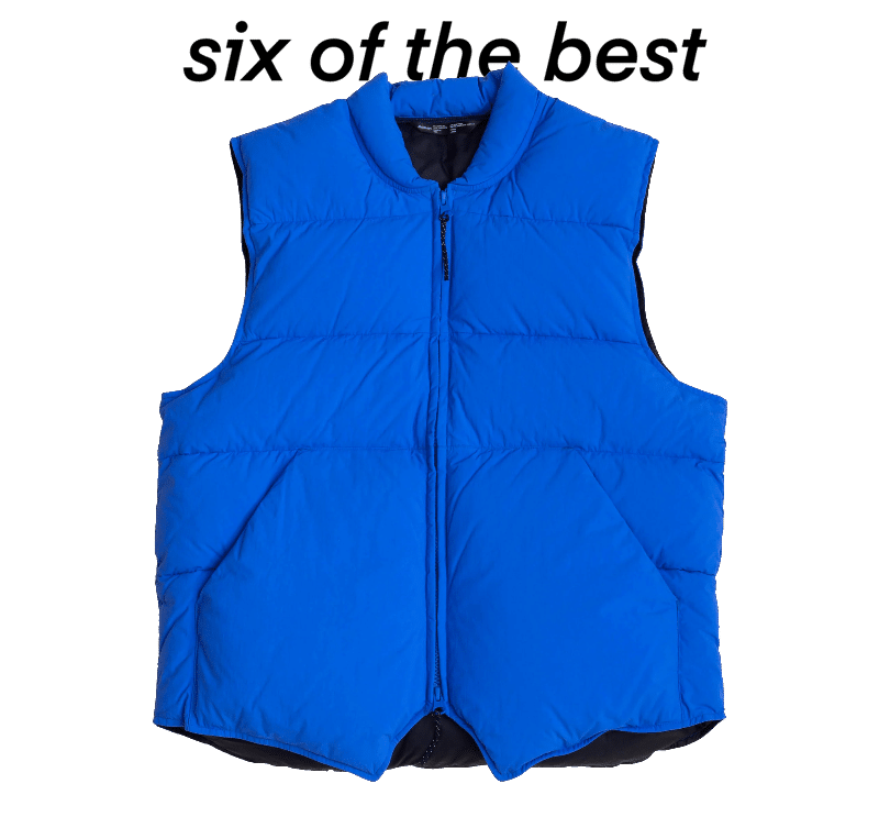 Vibrant blue puffer vest with high collar and quilted panels.