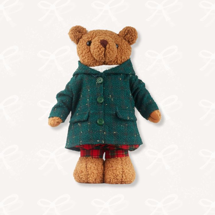 Soft plush teddy bear wearing a festive scarf.