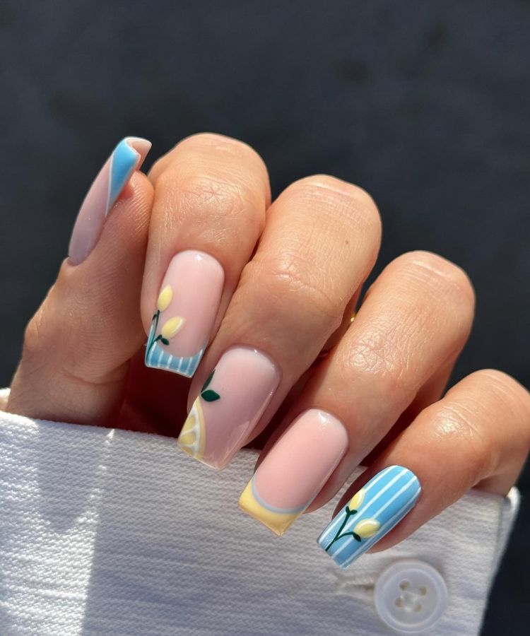 Bright aqua blue manicure on a hand holding a drink, coastal summer vibe.