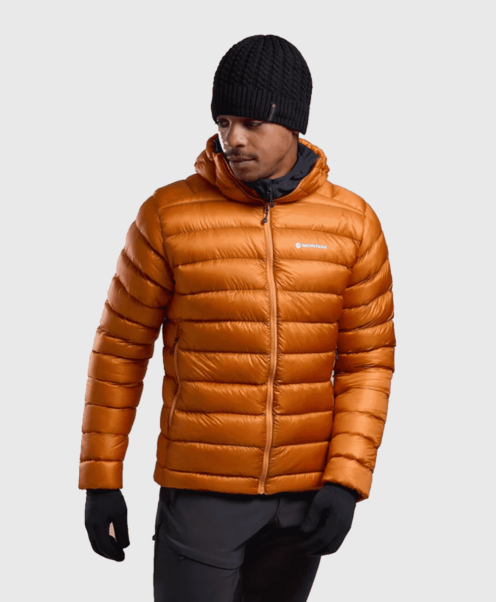 A man modeling a vibrant orange quilted down jacket with a hood.