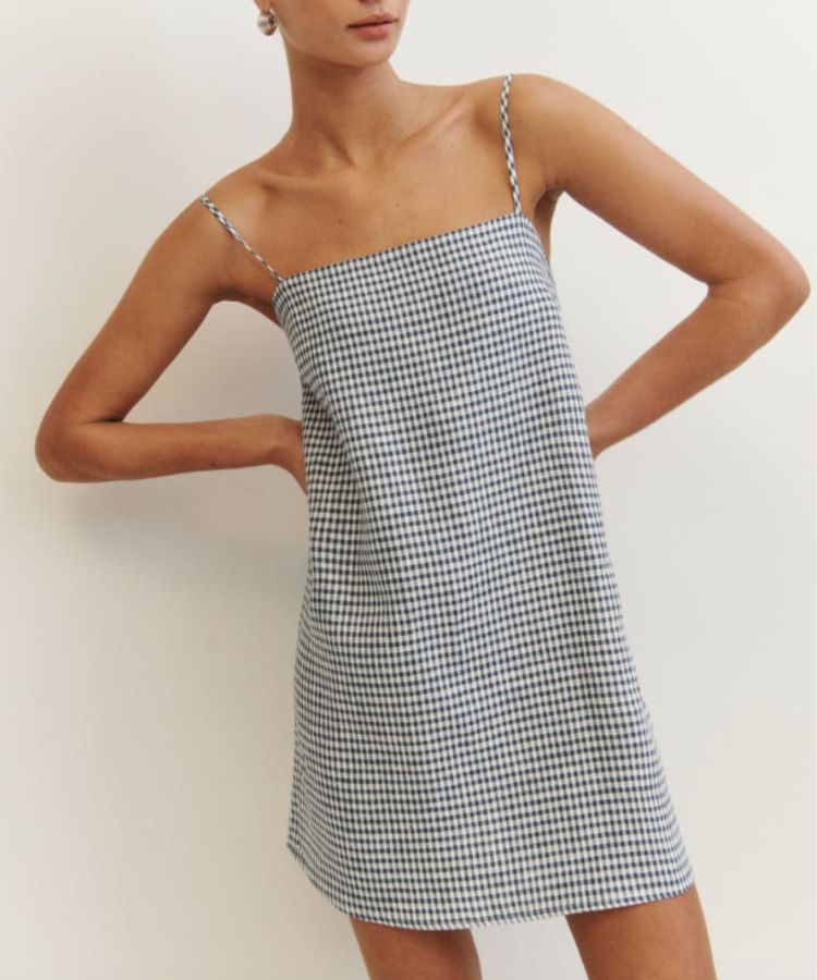 White linen midi dress with a fitted waist from Reformation.