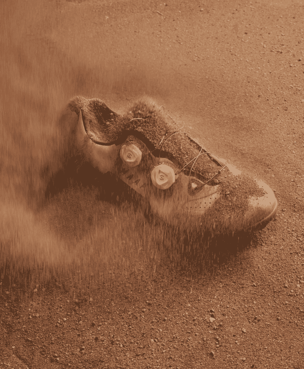 MAAP cycling shoe in motion on a dusty gravel trail.