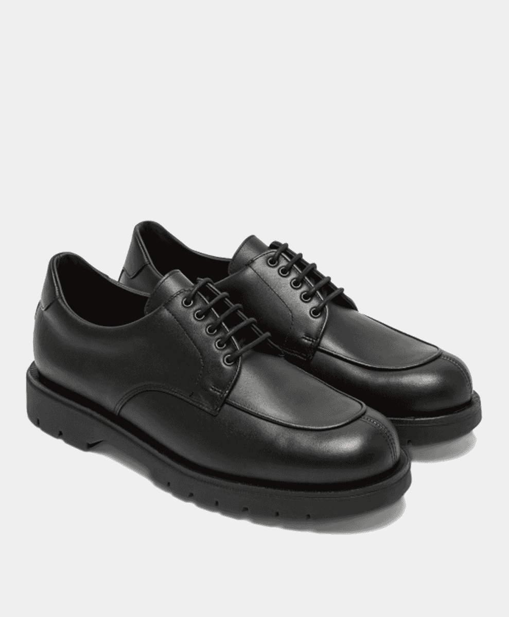 Polished black leather dress shoes with thick rubber soles.