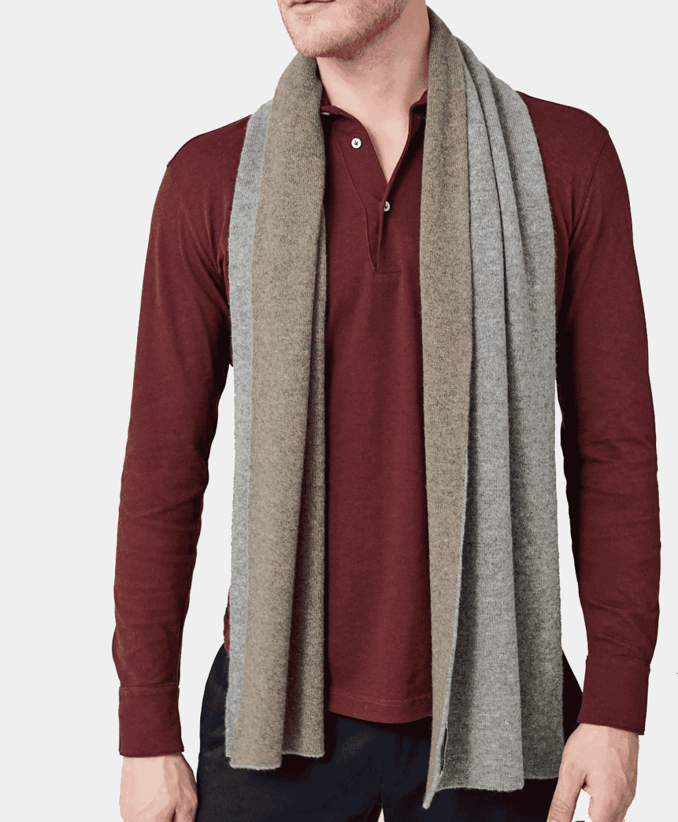 Man modeling a two-toned grey and beige cashmere scarf.