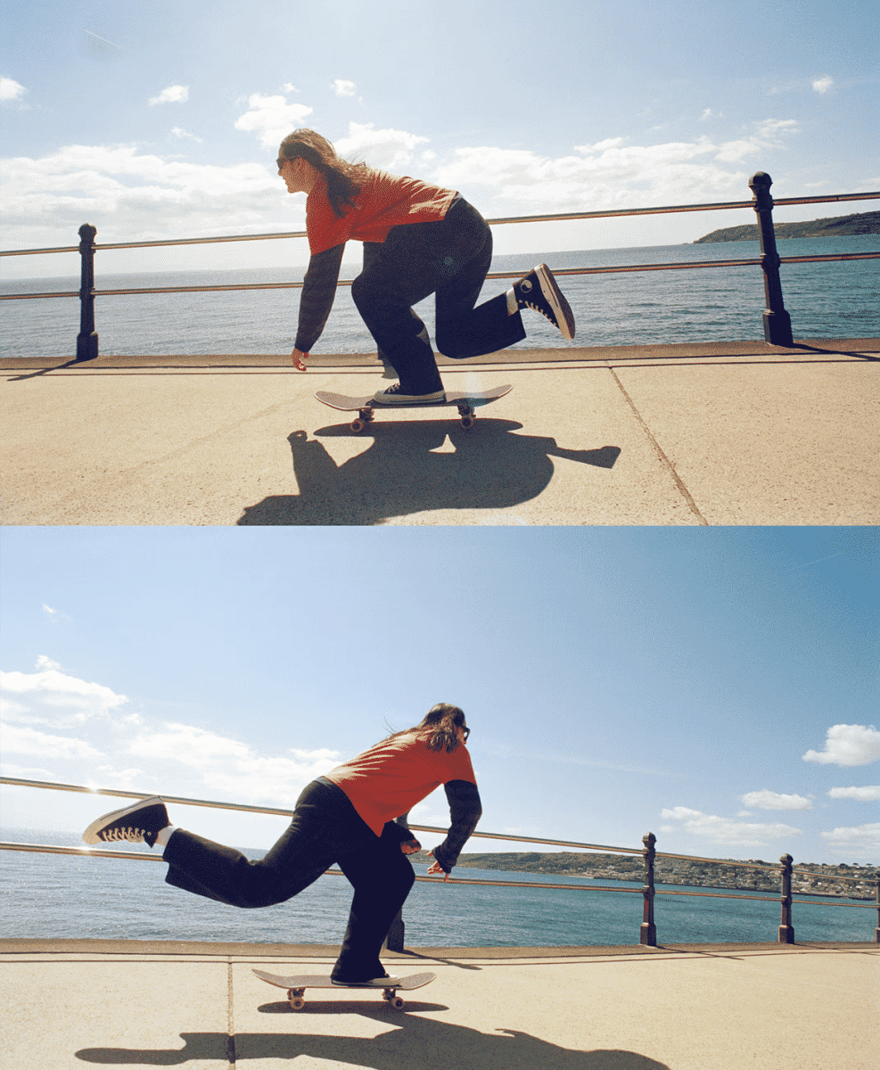 A person in an orange top and wide-leg pants skateboarding in black Converse sneakers.