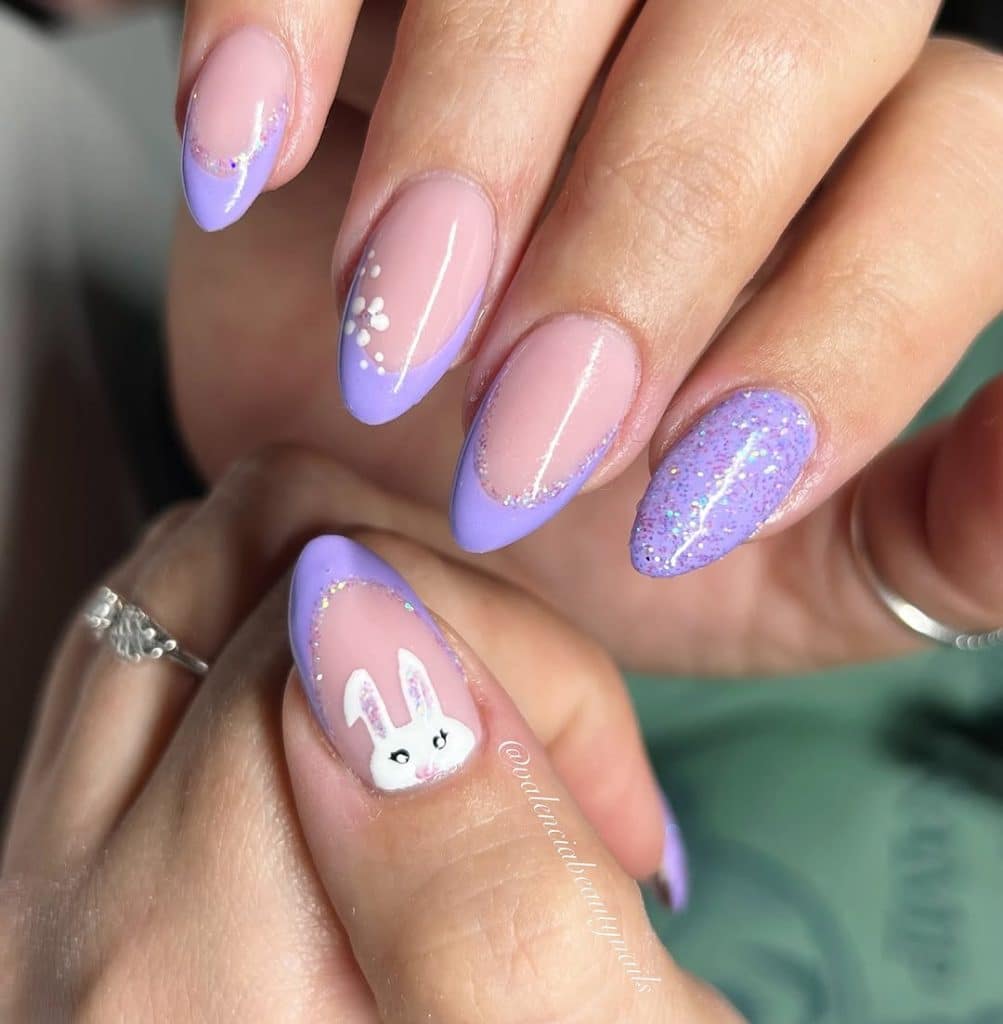 Intricate Easter nail art with lavender, pink, glitter, and a bunny design.