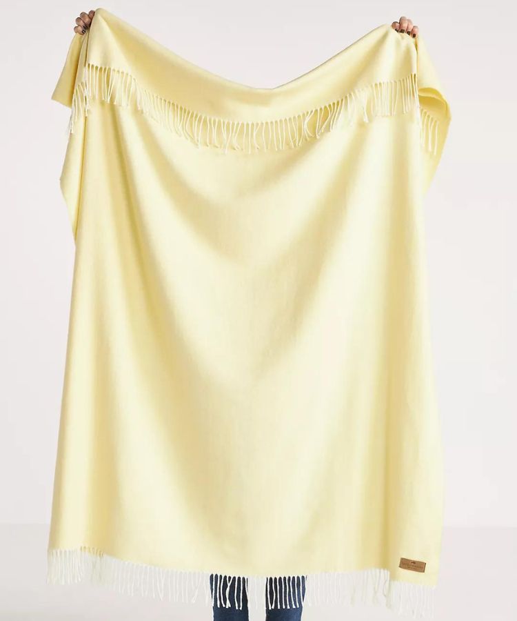Yellow throw blanket with a herringbone weave pattern.