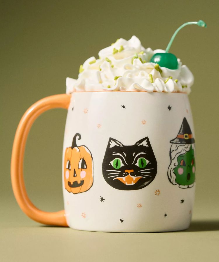 White stoneware mug featuring simple, whimsical black ghost and bat illustrations.