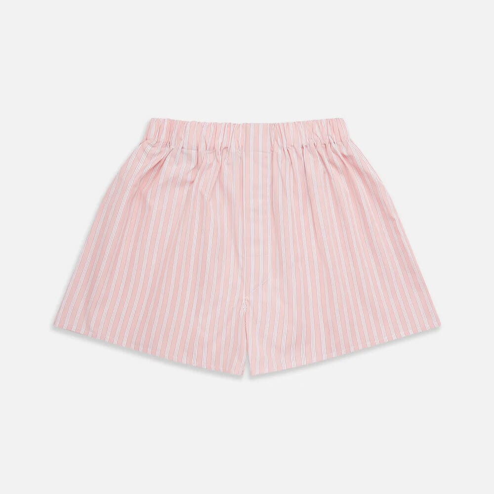 Pink boxer shorts with white vertical stripes and a relaxed fit displayed against a neutral background.