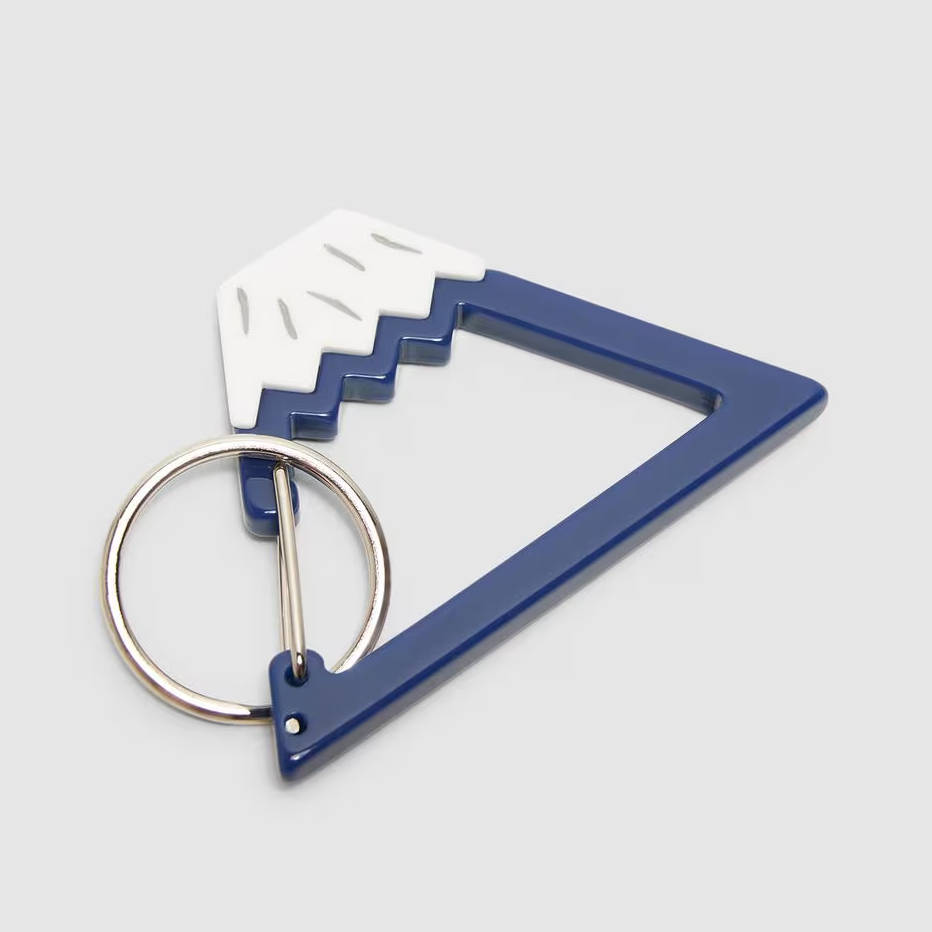 Blue and white triangular keychain with a mountain motif by Beams.