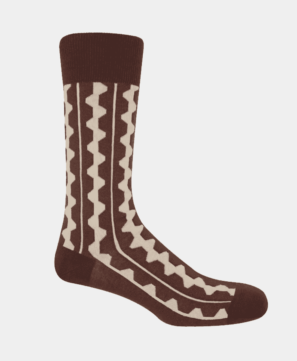 A single brown sock with a cream geometric zigzag pattern.