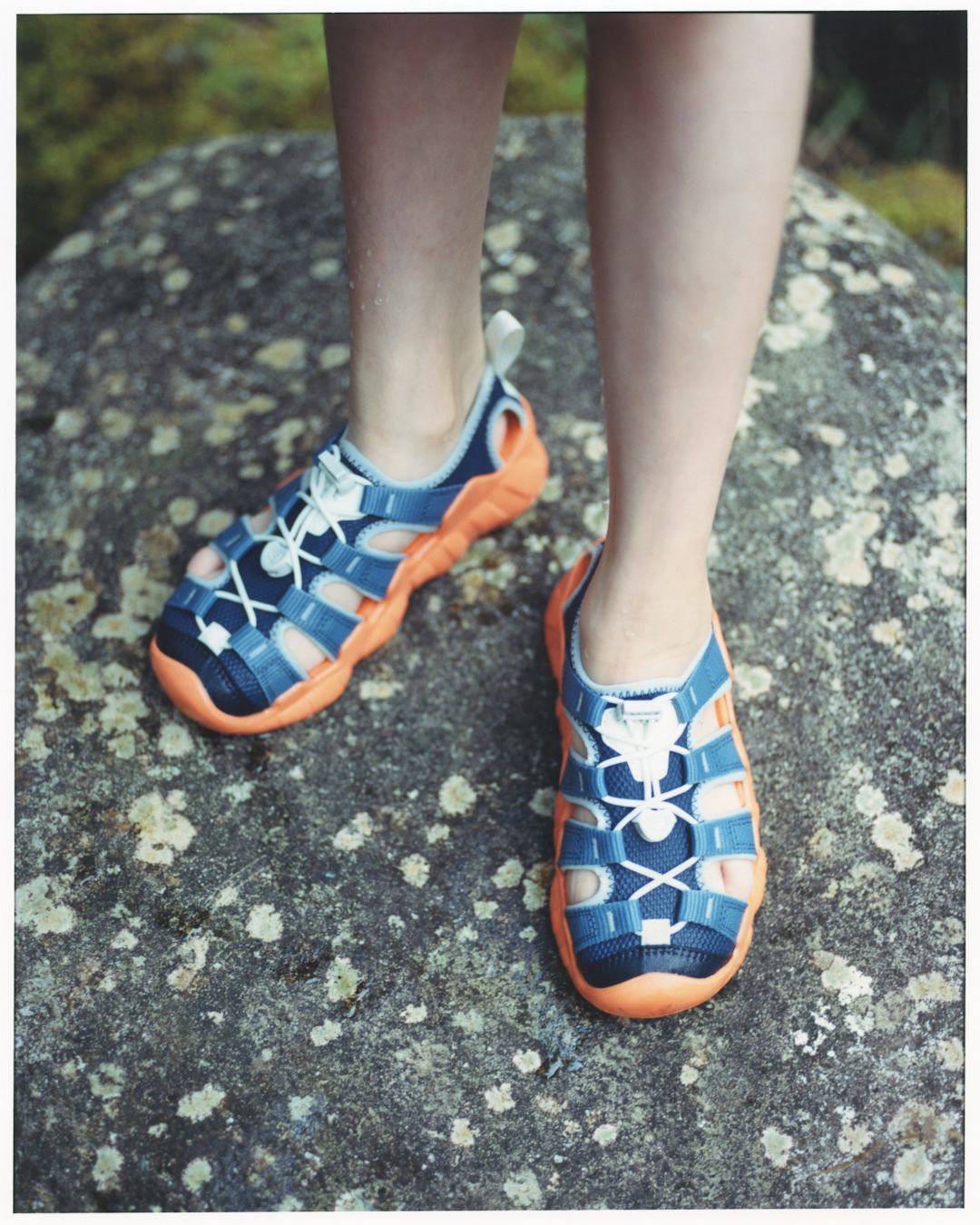 Vibrant blue and orange children's version of the KEEN Hyperport in a natural play setting.