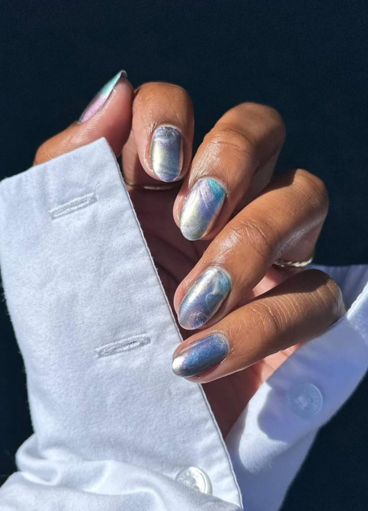 Icy blue chrome nails with a mirror-like reflective finish.