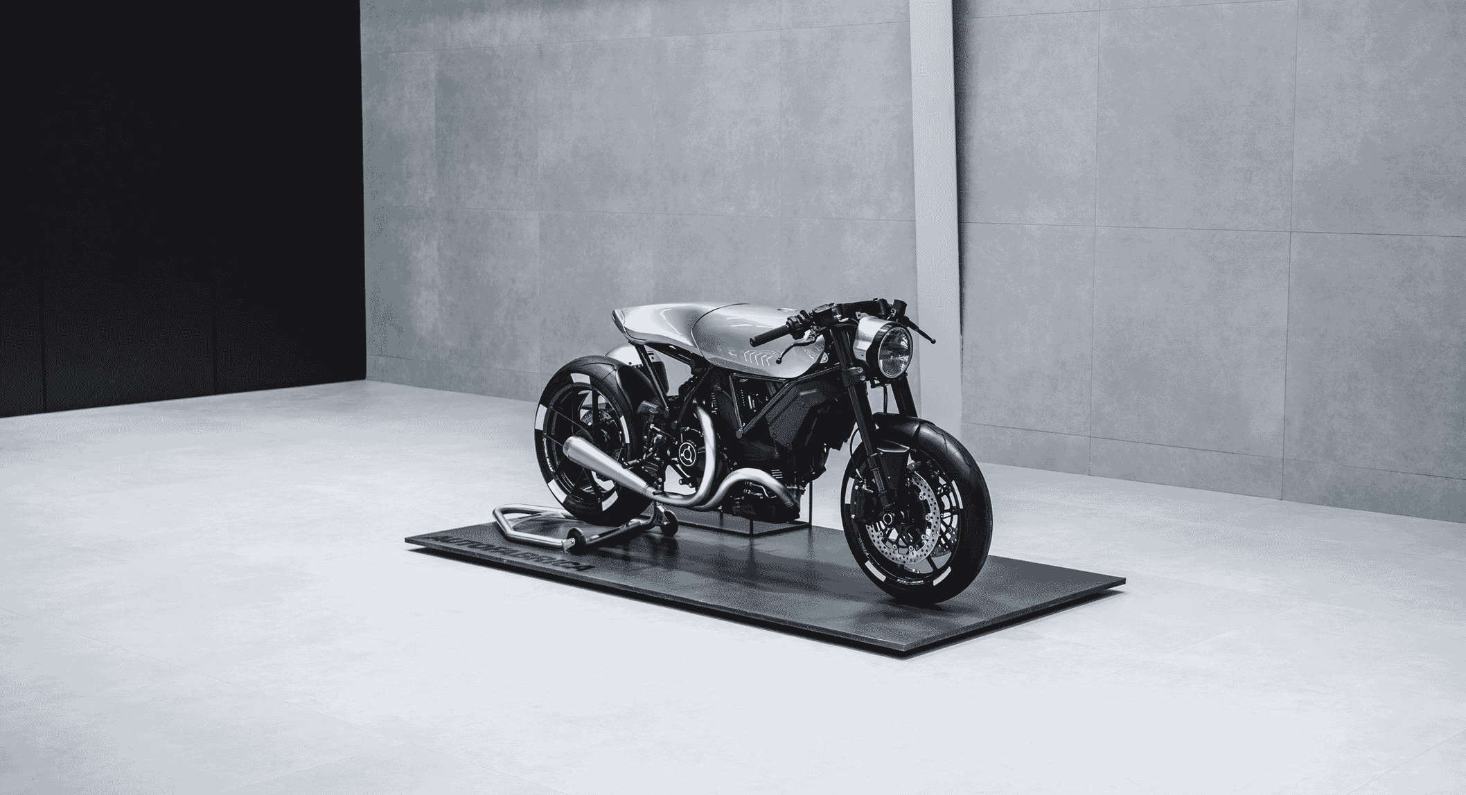 Wide-angle side view of the Type 23 custom motorcycle showcasing its minimalist design and chrome accents.