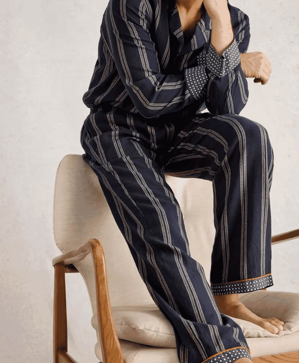 Navy blue striped pajama set featuring contrasting polka dot cuffs and collar.