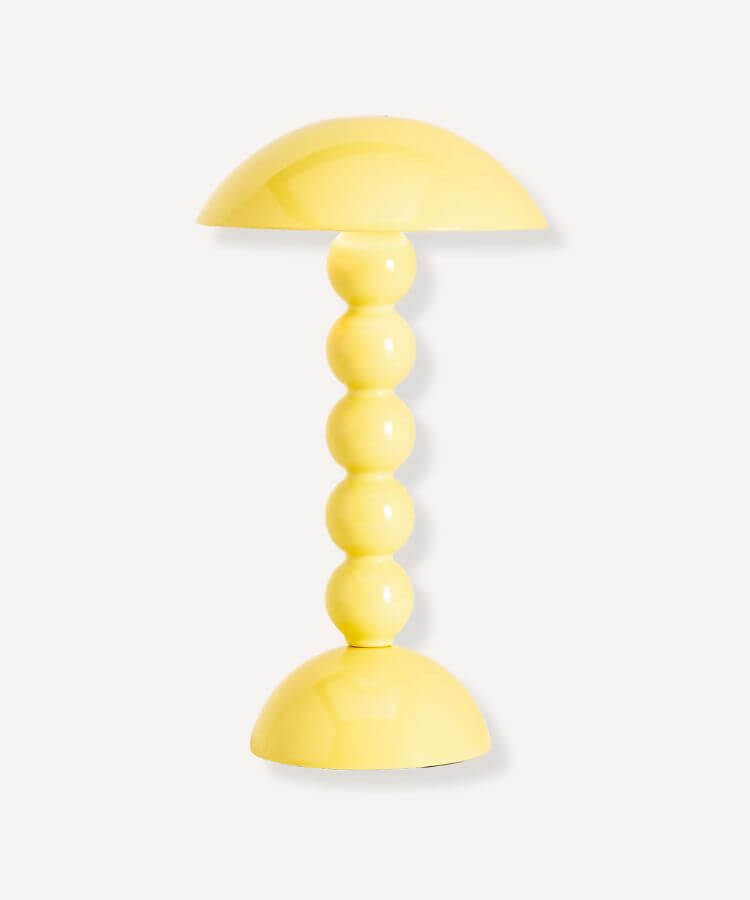Cordless rechargeable table lamp with a bobbin-style base in yellow.