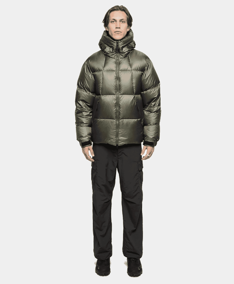 Model in metallic olive-green puffer jacket and black cargo pants.