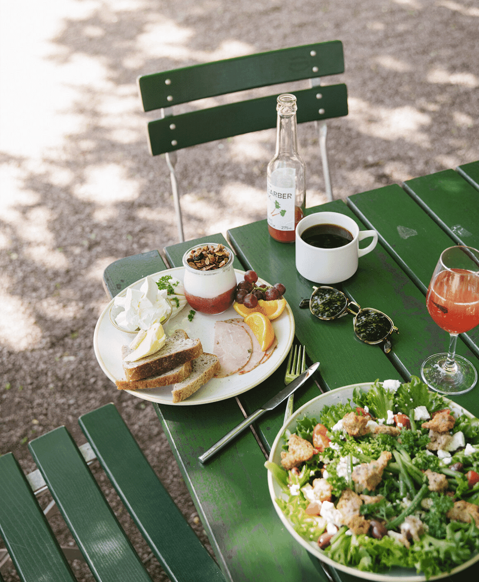 Top-down view of an elegant breakfast spread with yogurt, granola, and coffee.