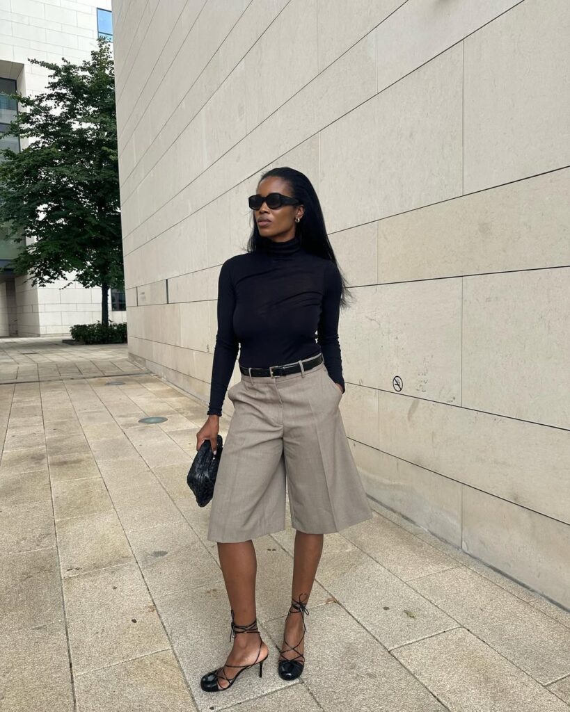 Dark wash professional denim paired with a structured tweed jacket.