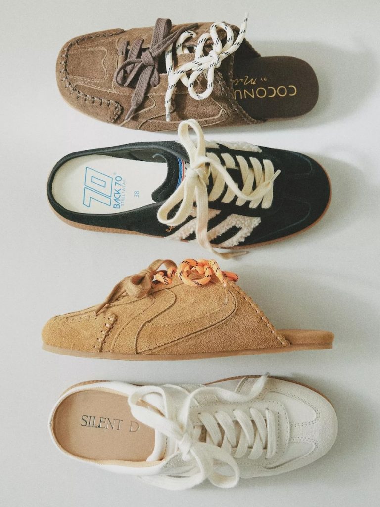 Sneaker mules paired with relaxed-fit denim jeans in a lifestyle setting.