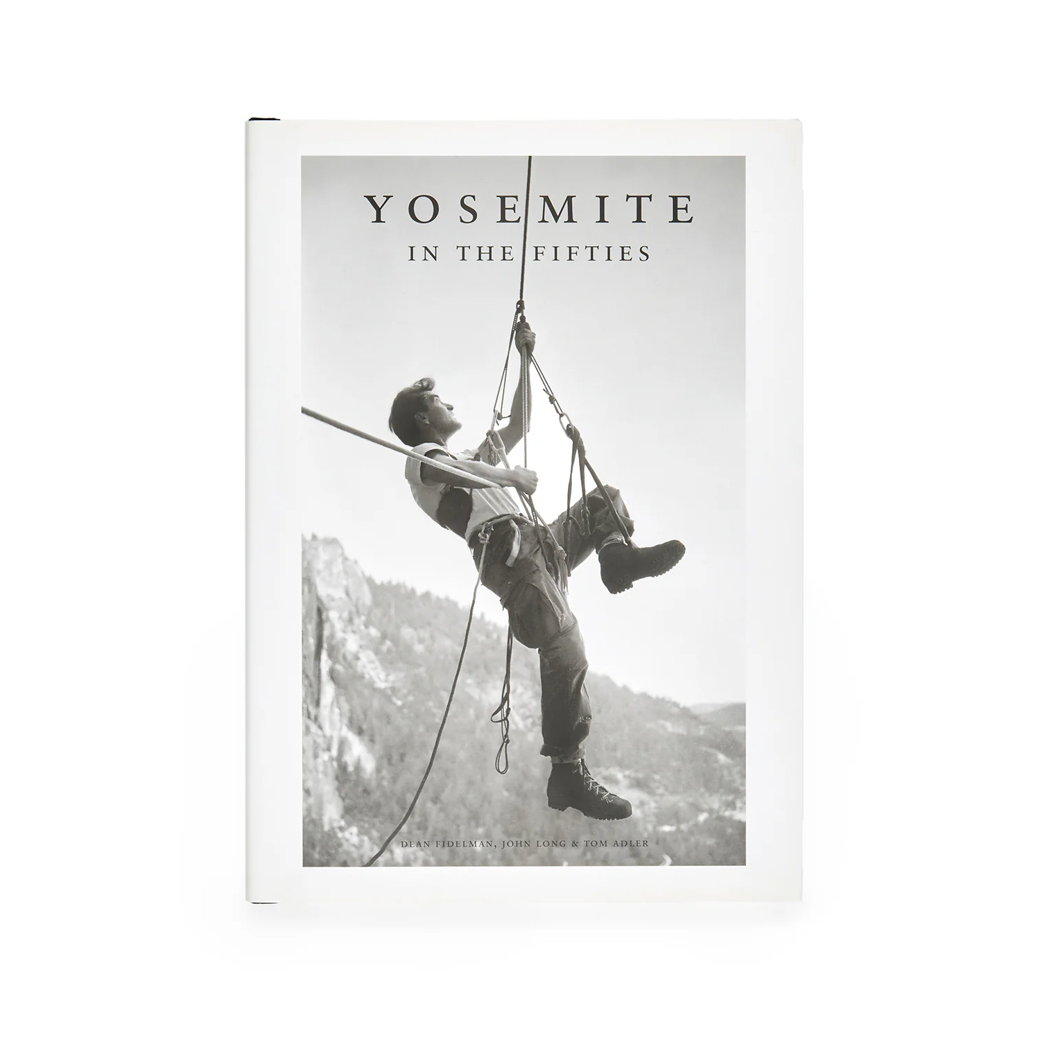 Black-and-white photo of a rock climber in Yosemite during the 1950s in rugged gear.