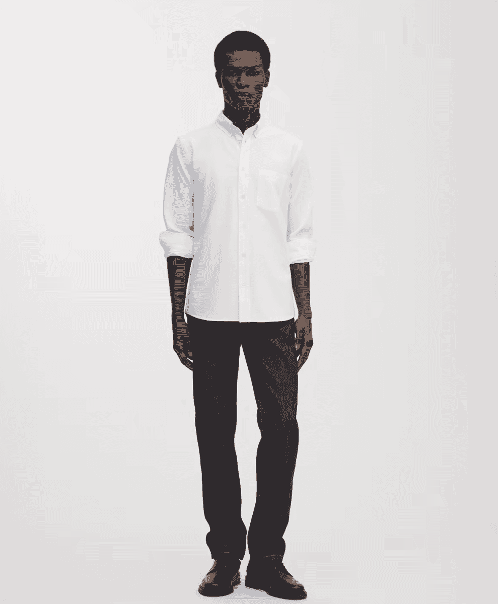 A man in a crisp white Oxford button-down shirt with sleeves rolled up.