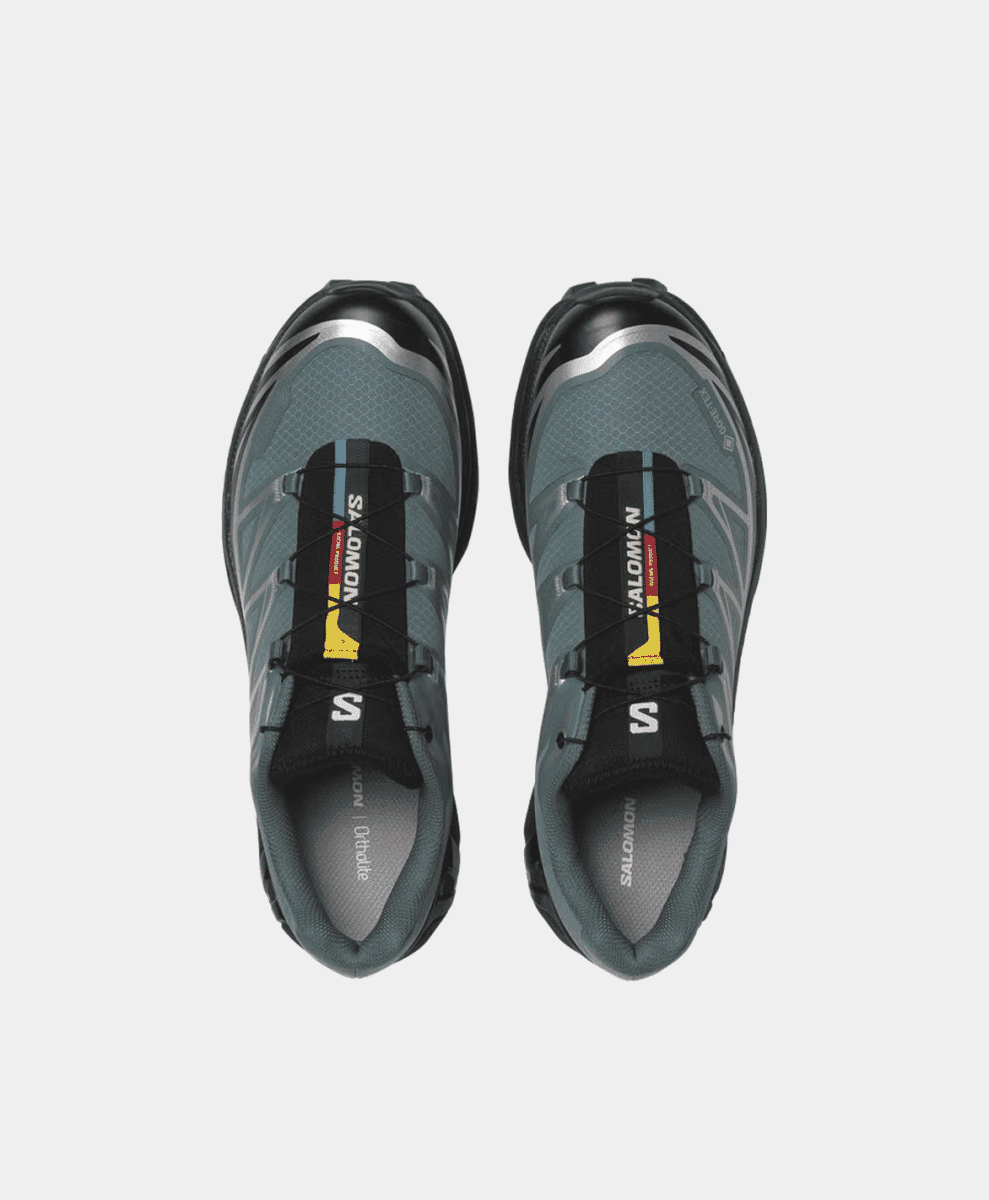 Top-down view of gray Salomon trail shoes showing the interior Ortholite soles.