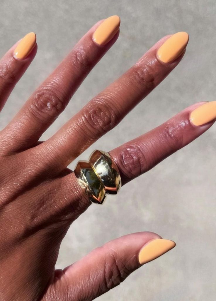 Soft apricot orange manicure with a creamy finish.