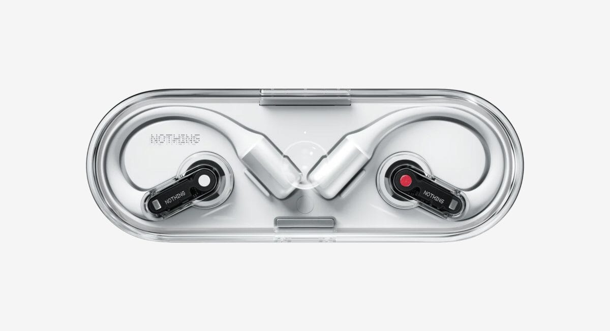 White Nothing earphones in their clear, transparent charging case.
