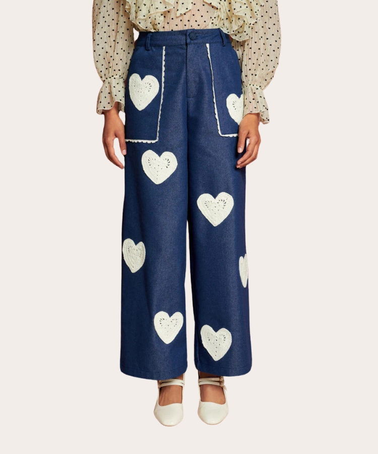 Pink trousers with embroidered red hearts.