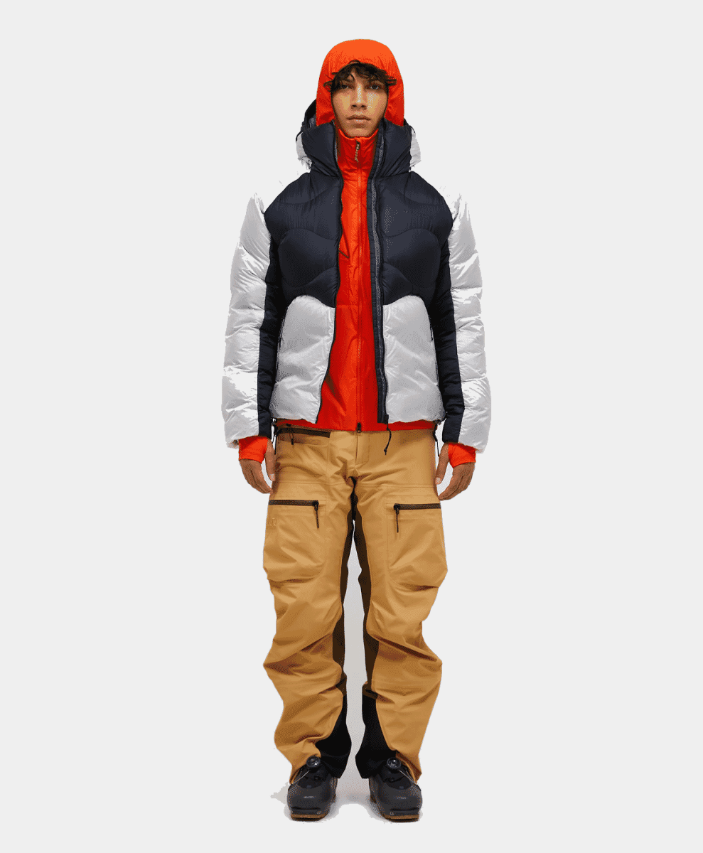 Model wearing an orange, white, and navy color-blocked puffer jacket.