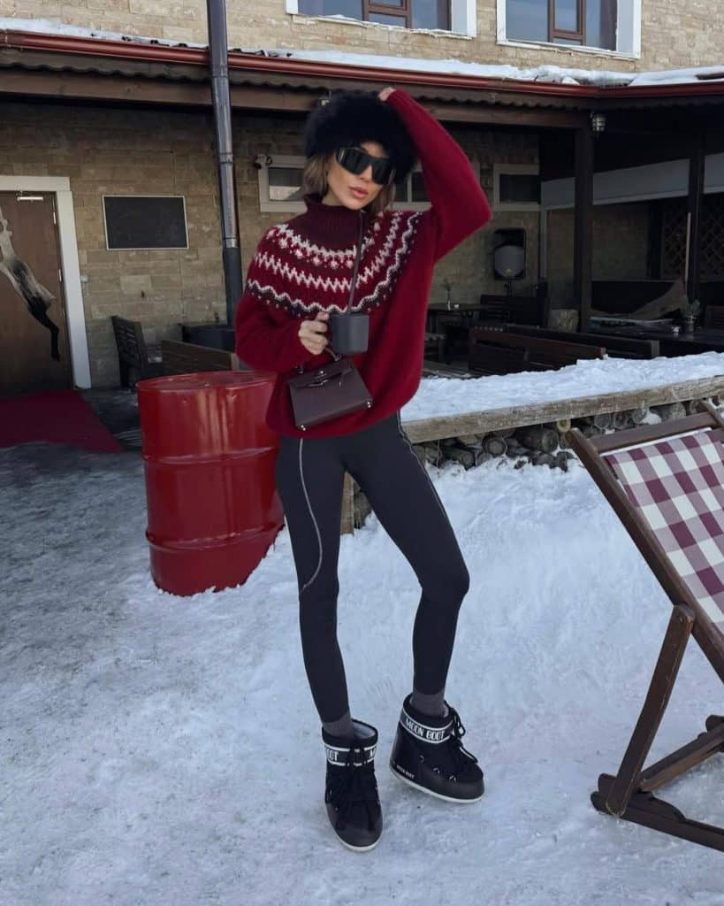 Woman in a red Fair Isle sweater and Moon Boots.