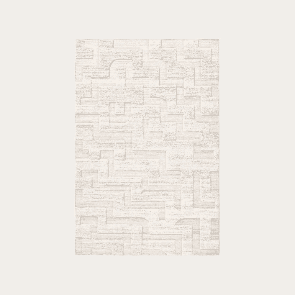 Detail shot of a light-colored rug with a complex, maze-like geometric texture and tonal variations.