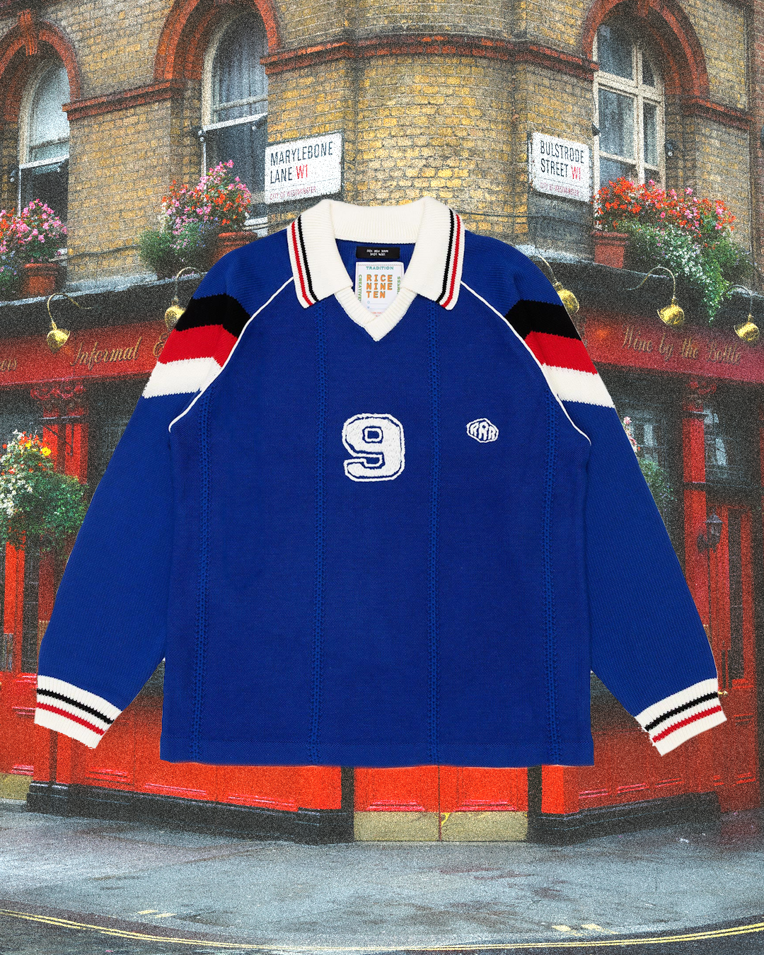 A blue knitted rugby-style sweater with a white number nine and red/white striped sleeves.