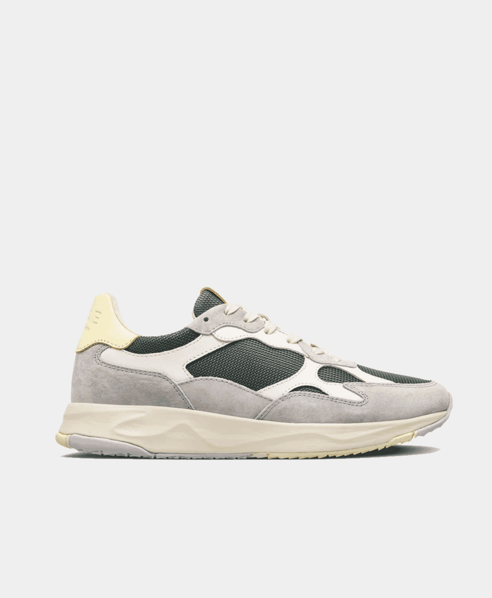 Profile view of the grey and dark green Joshua vegan sneaker against a white background.