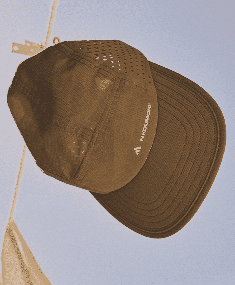 Brown perforated running cap with H.KOUMORI branding.