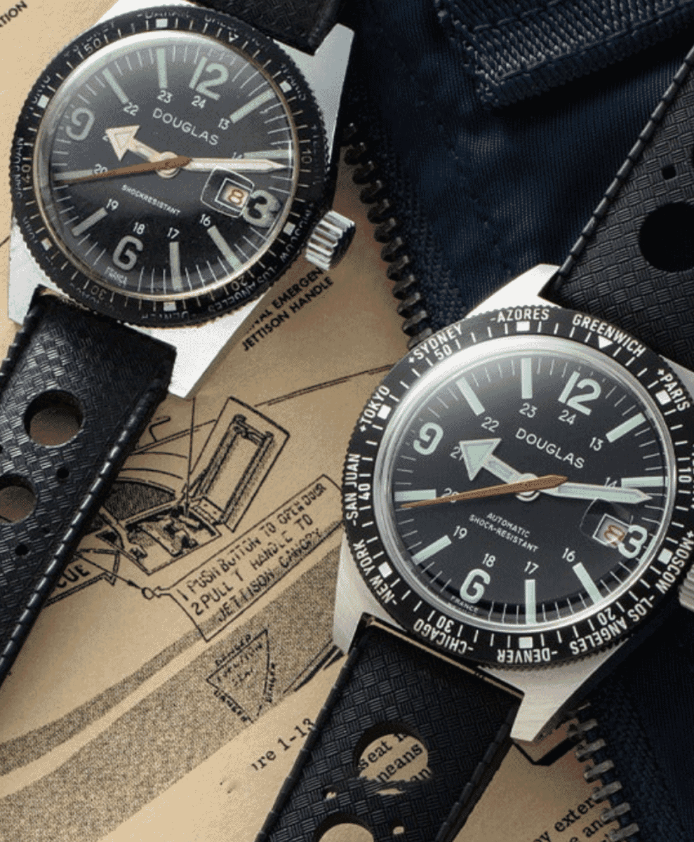Douglas wristwatches with black dials placed on a vintage aviation manual.