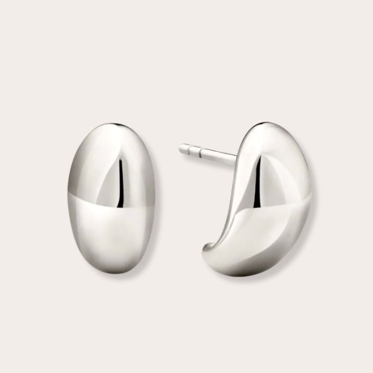 Mejuri Dome Huggies silver earrings.