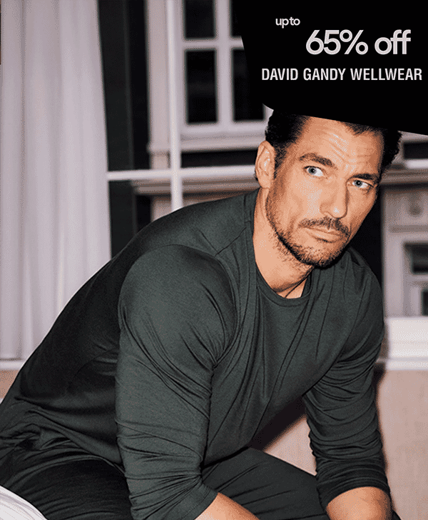 A man in dark green activewear with a 65% off David Gandy Wellwear banner.