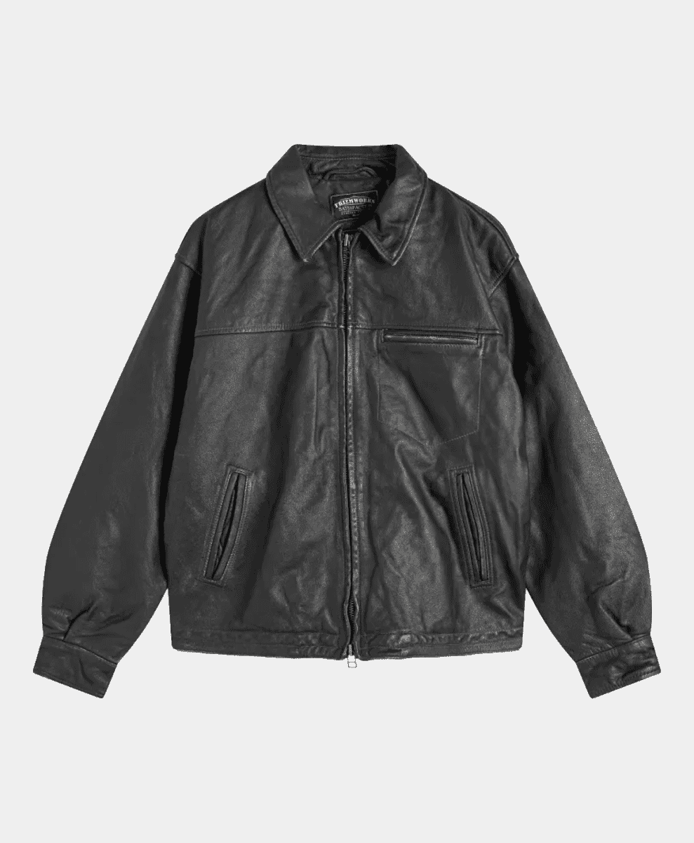 Flat lay of a classic black leather jacket with a collar and front zipper.