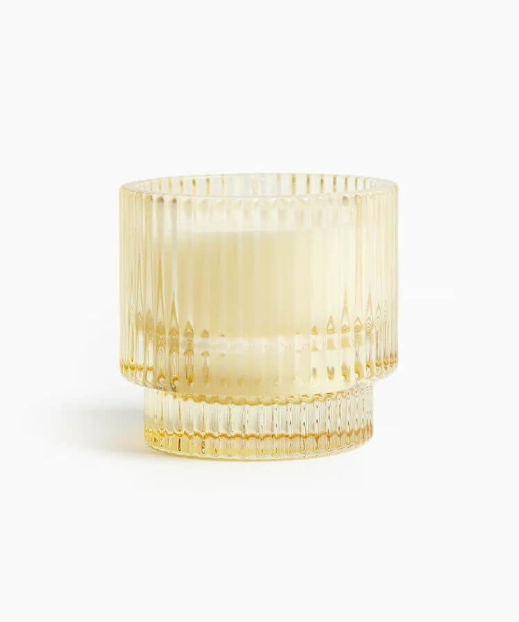 Scented candle in a yellow jar labeled Grapefruit Nectar.