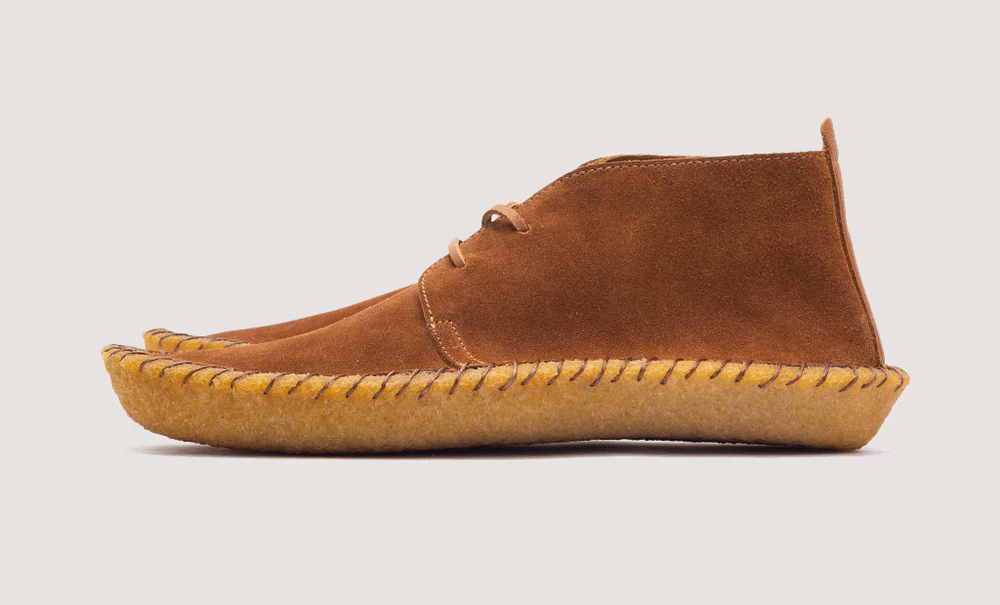 Tan suede chukka boot with visible sole stitching and a minimalist silhouette.
