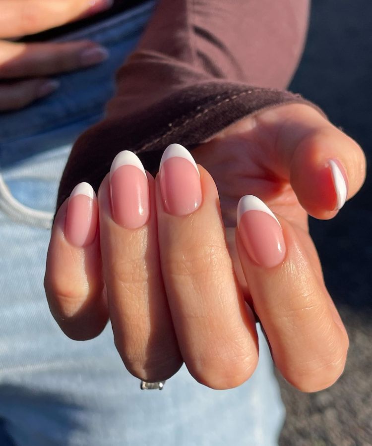 Modern French manicure with crisp white tips and a sheer base.